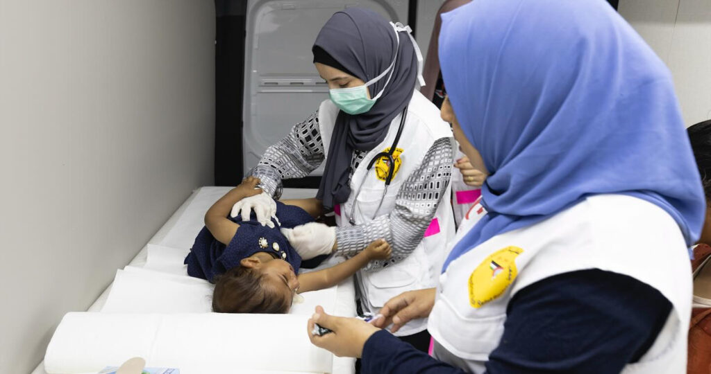 Photo of a child taken care of by medical staff.
